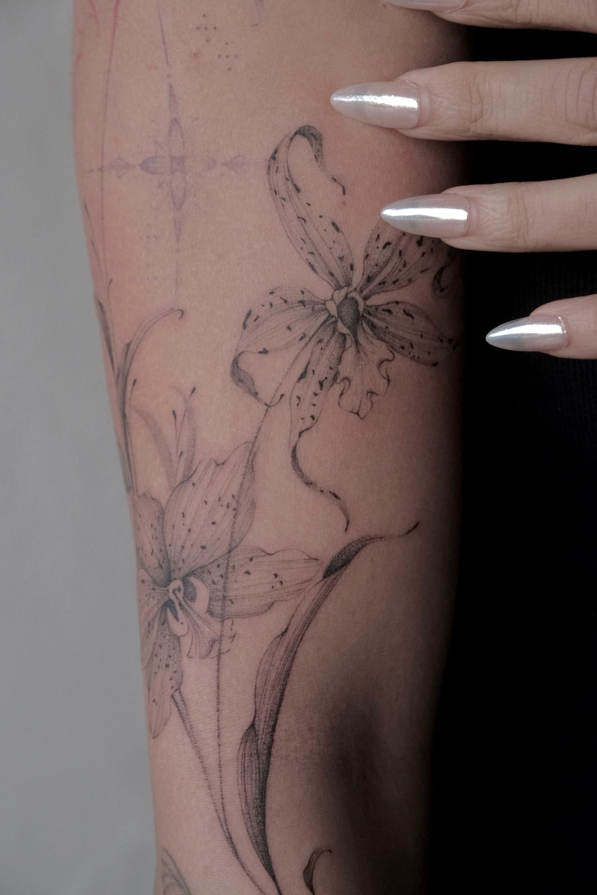 Fine line lily on the inner forearm